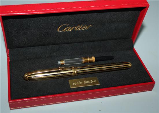 Louis Cartier Dandy limited edition gold-plated and black enamel fountain pen, cased, with extra cartridges